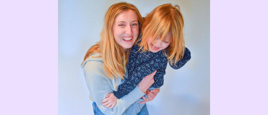 Founder Julia holding autistic girl model in her sensory clothing designs