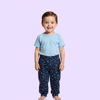 Child wearing a light blue compression shirt and dark patterned pants on a light purple background