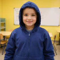 Child wearing a blue sound reducing hoodie in a classroom.