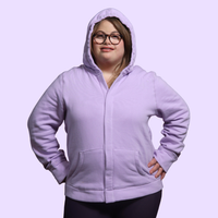 Adult with down syndrome wearing sensory hoodie with sound reducing hood pulled up and magnetic closures shut.