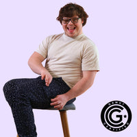 Man with down syndrome showing off magnetic fidget pocket on sensory pants with GAMUT Seal of Approval in bottom right corner.