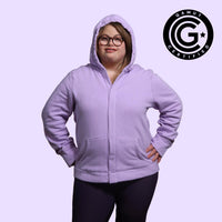 Adult with down syndrome wearing sensory hoodie with sound reducing hood pulled up and magnetic closures shut. GAMUT Seal of Approval™ in the top right corner.