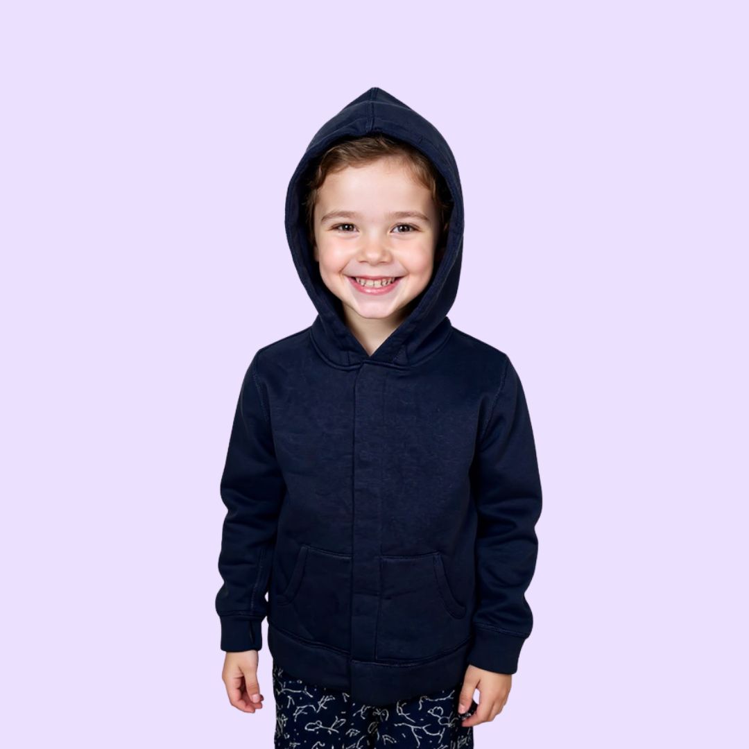 Autistic child wearing navy sound reducing sensory hoodie with adaptive magnetic closure.