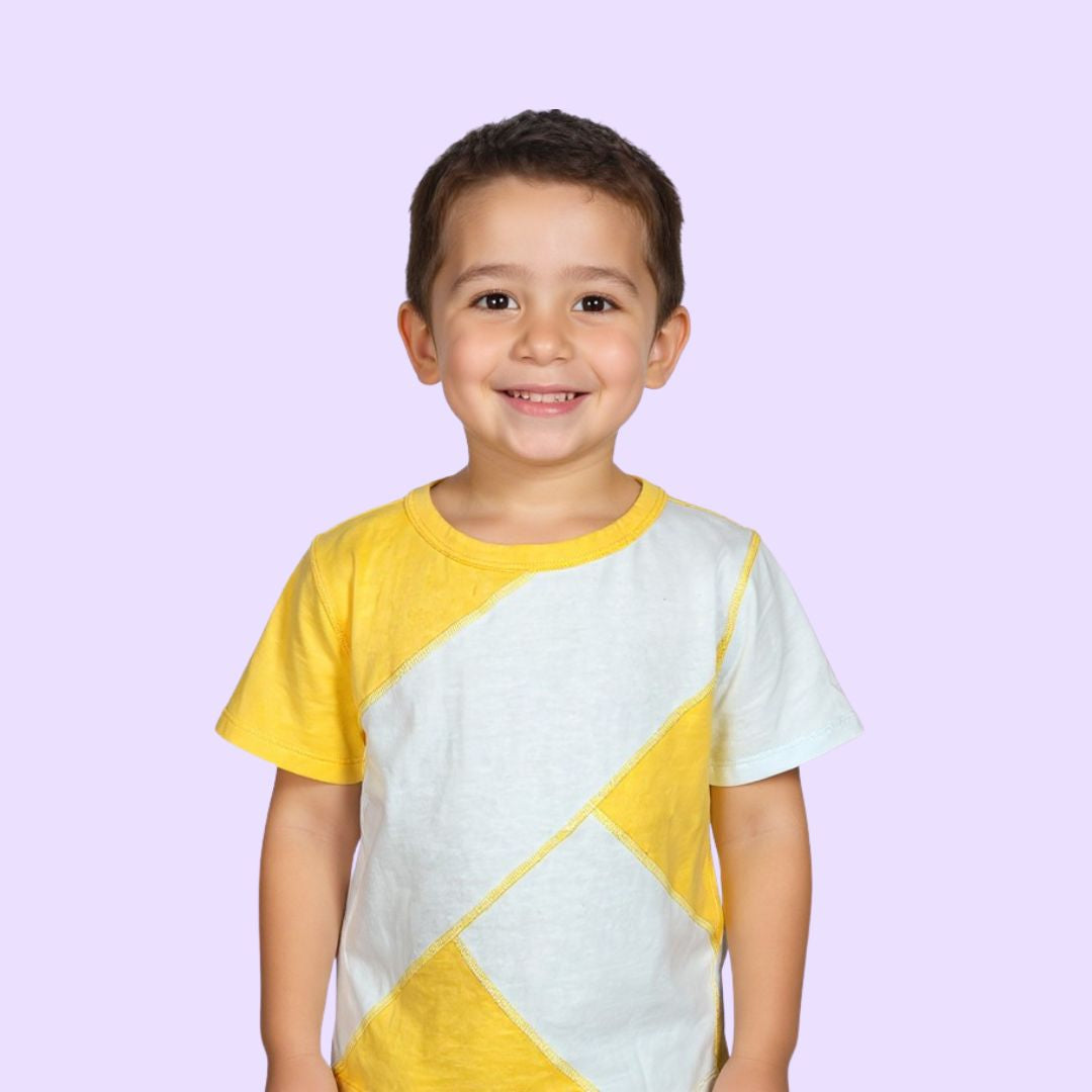 Child wearing a yellow and light blue geometric patterned sensory friendly shirt on a light purple background