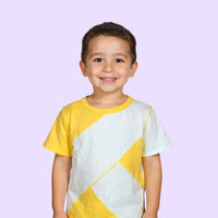 Child wearing a yellow and light blue geometric patterned sensory friendly shirt on a light purple background