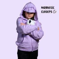 Sensory hoodie on a girl with the hood up and eye mask covering her eyes. Holding a stuffed panda in her arms.