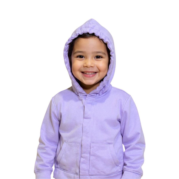 A sensory-sensitive child wearing the QuietSense hoodie with the sound-reducing hood pulled up, shown in a calm environment demonstrating a sensory regulation moment