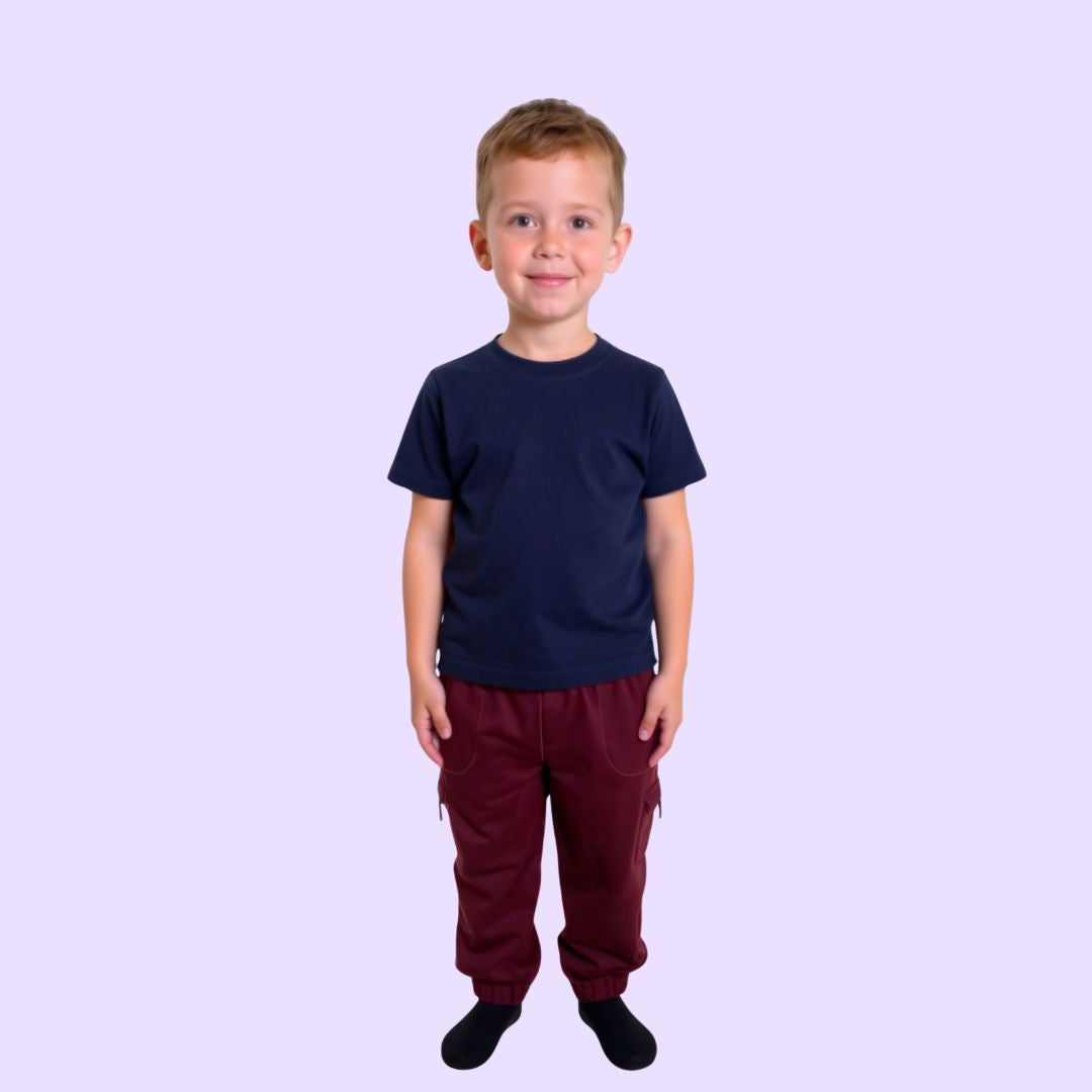 Child wearing a navy compression shirt and red pants on a light purple background