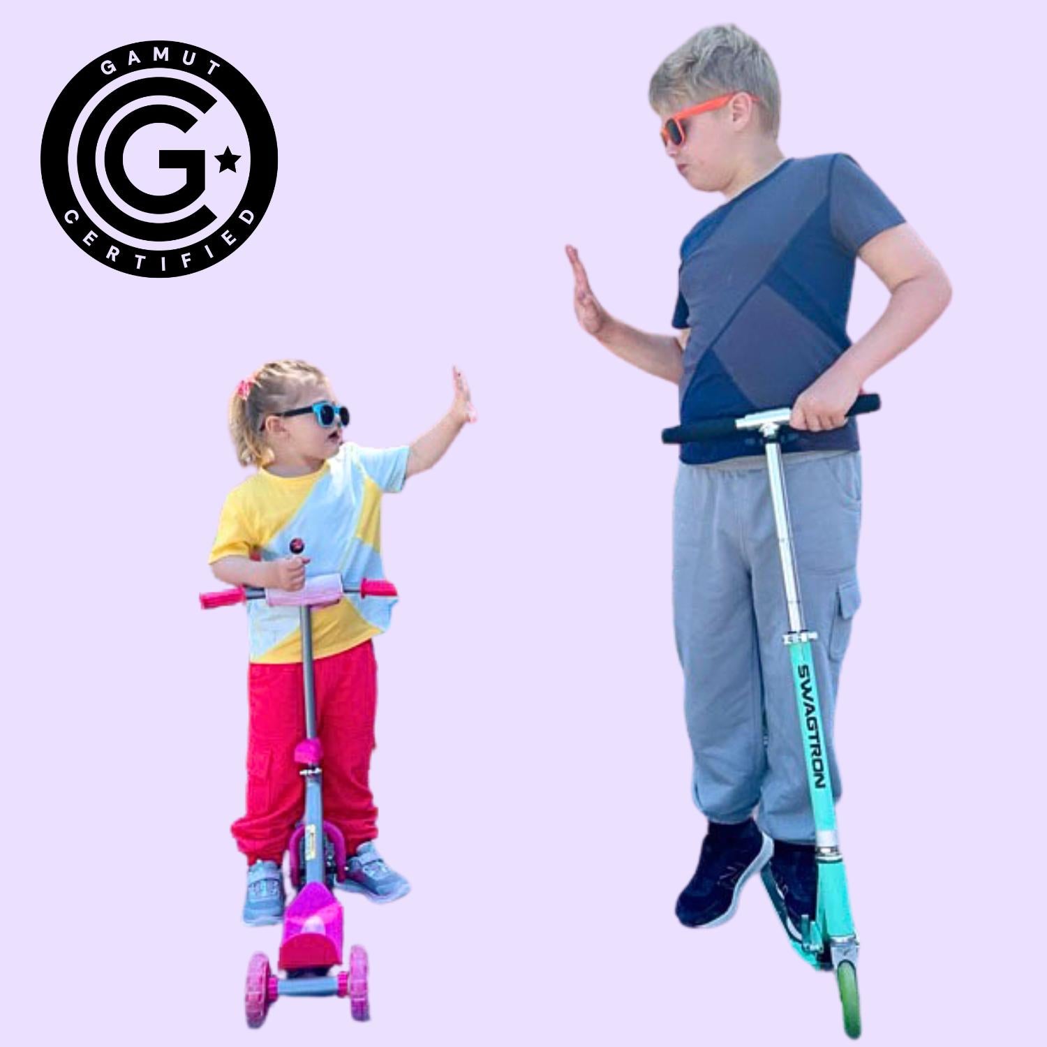 Two children with scooters in sensory t-shirts and joggers with the GAMUT Seal of Approval™ in the top left corner.