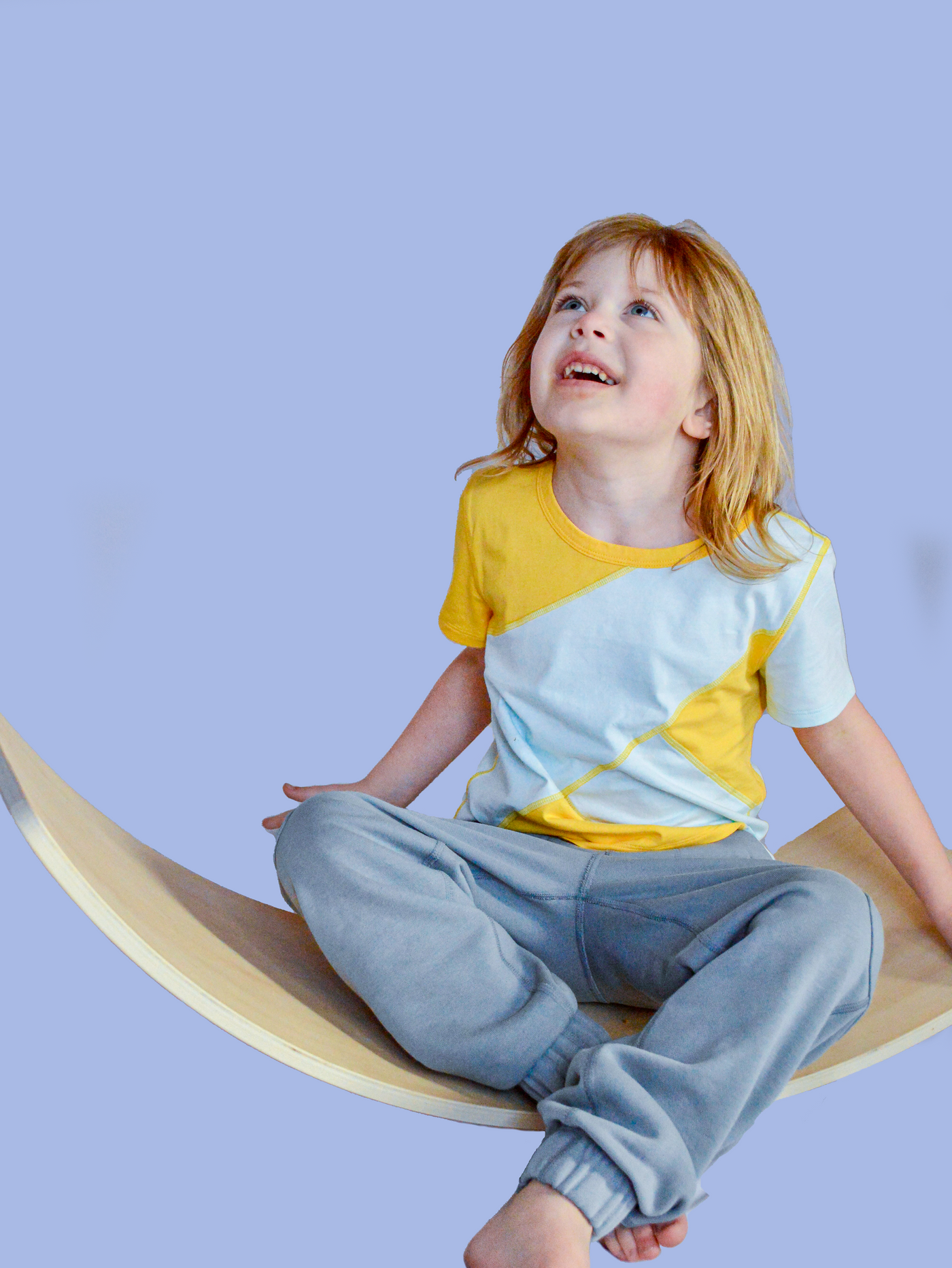 autistic child regulated with sensory tools in sensory friendly clothing. 