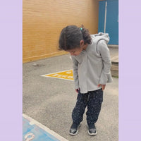 student playing with fidget on jogger pocket.